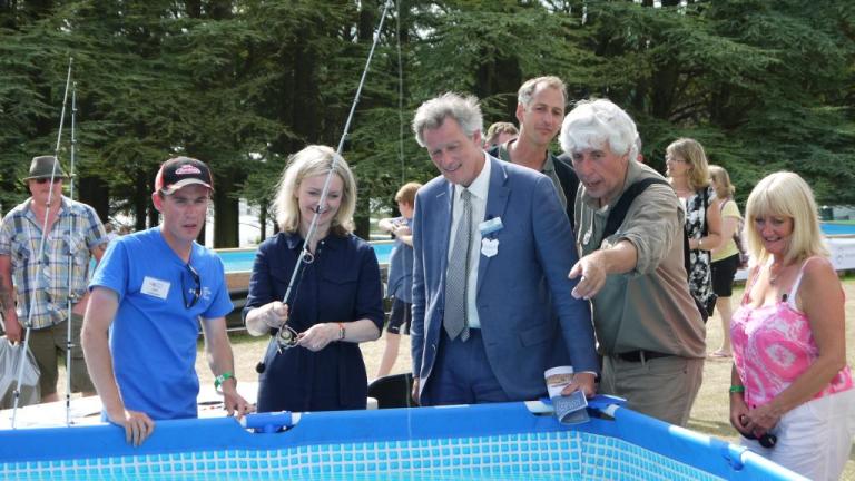 Showing the new Environment Secretary some of the finer points of lure fishing at the Angling trust stand at this year's Game Fair.