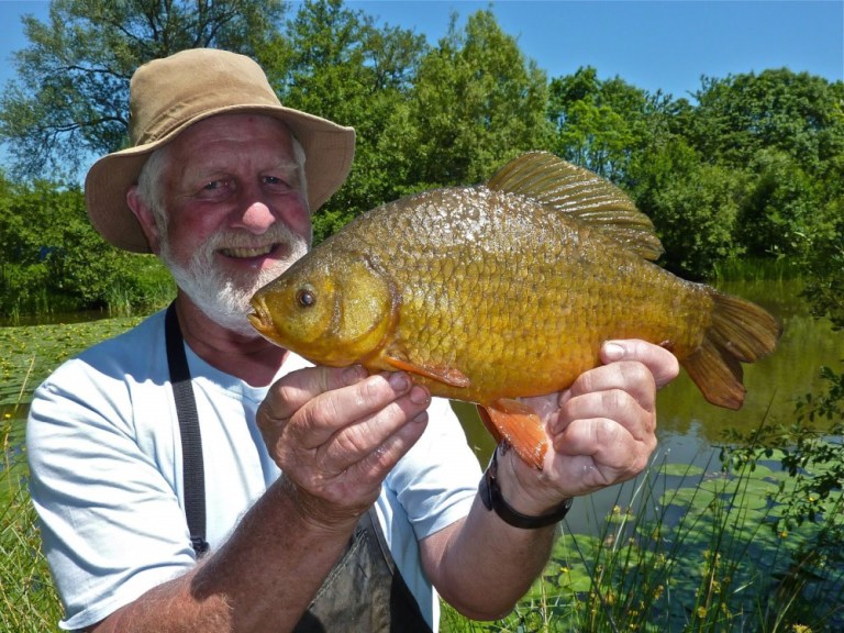 Wildlife film maker Hugh Miles with one of the beautiful crucians from Peter's ponds