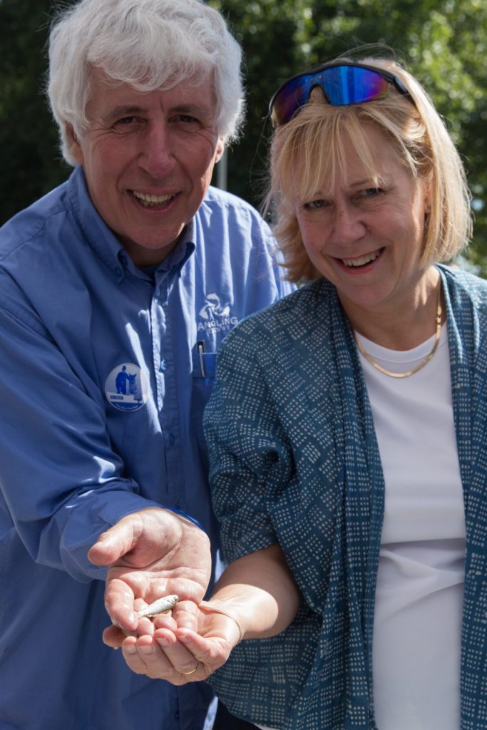 Martin and local MP Ruth Cadbury with a baby bass caught while river dipping at this year's TideFest 